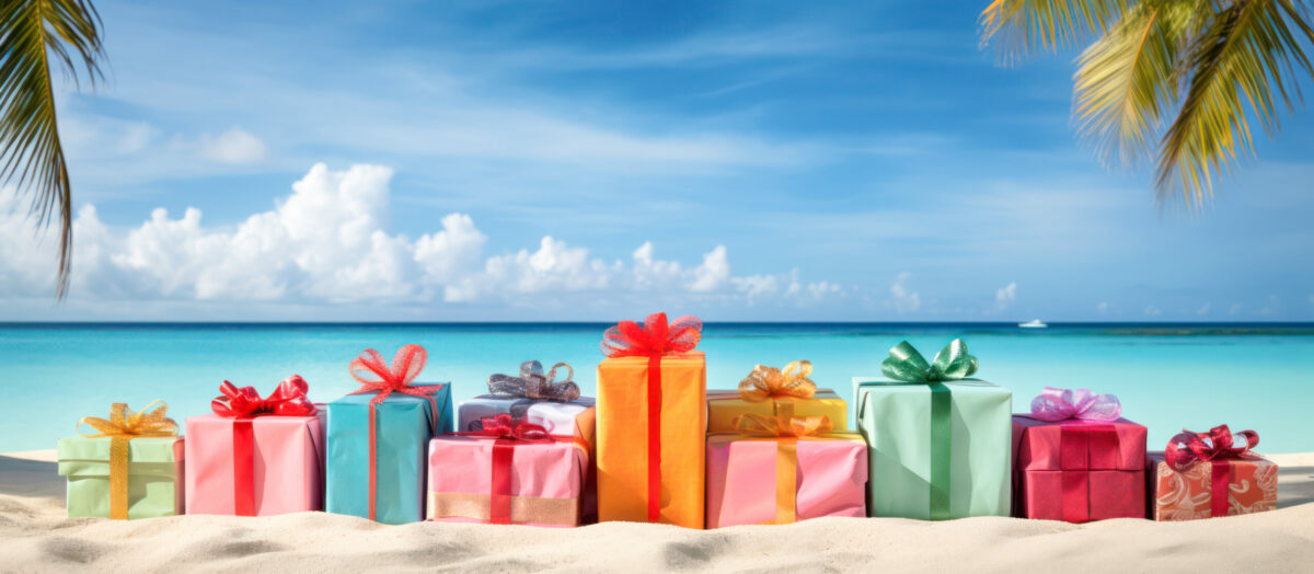 Gift boxes on a tropical beach as panorama background